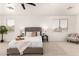 Well-lit main bedroom features neutral decor, a ceiling fan, and a comfortable sitting area at 135 E Julian Dr, Gilbert, AZ 85295