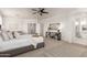 Large, bright main bedroom with neutral decor, ceiling fan, and an ensuite bathroom at 135 E Julian Dr, Gilbert, AZ 85295