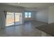 Bright living room with tile flooring, a sliding glass door to the backyard at 1428 W Kennedy Ave, Coolidge, AZ 85128