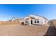 Backyard view of the home with a covered patio and block wall at 16580 N Dante Way, Maricopa, AZ 85138