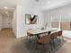 Contemporary dining room bathed in natural light, with a designer table and modern decor at 16580 N Dante Way, Maricopa, AZ 85138