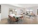 Bright, open-concept living space with a modern dining table and a comfortable seating area at 16580 N Dante Way, Maricopa, AZ 85138
