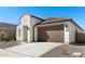 Charming one-story home showcasing a 2-car garage and simple desert landscaping at 16580 N Dante Way, Maricopa, AZ 85138