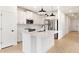 Contemporary kitchen with stainless steel appliances, white cabinetry, and a quartz countertop island at 16580 N Dante Way, Maricopa, AZ 85138