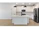 Modern kitchen featuring stainless steel appliances, quartz countertops, and sleek white cabinets at 16580 N Dante Way, Maricopa, AZ 85138