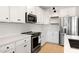 Close-up of a modern kitchen featuring stainless steel appliances and stunning quartz countertops at 16580 N Dante Way, Maricopa, AZ 85138