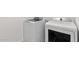 Bright laundry room equipped with modern, white front-load washer and dryer for efficient and convenient laundry care at 16580 N Dante Way, Maricopa, AZ 85138