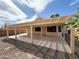 This covered patio provides a shaded retreat for outdoor relaxation and entertainment in this low maintenance yard at 18068 W Browning Dr, Surprise, AZ 85374