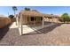 A covered patio offers a shaded retreat in the low-maintenance backyard of this home at 18068 W Browning Dr, Surprise, AZ 85374