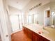 This bathroom features a large mirror, double sinks, and a glass-enclosed shower with tile flooring at 18068 W Browning Dr, Surprise, AZ 85374