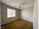 This bedroom offers a ceiling fan and ample natural light through a window with privacy blinds at 18068 W Browning Dr, Surprise, AZ 85374