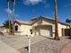 Single-story home featuring desert landscaping, a two-car garage, and a welcoming mailbox at 18068 W Browning Dr, Surprise, AZ 85374
