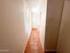 Bright hallway featuring neutral wall paint, tile floors and a window for natural light at 18068 W Browning Dr, Surprise, AZ 85374