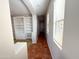 Neutral hallway featuring tile flooring and ample natural light from a window at 18068 W Browning Dr, Surprise, AZ 85374