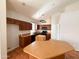 Kitchen featuring warm cabinets, tile floors, ample counter space, and modern appliances at 18068 W Browning Dr, Surprise, AZ 85374