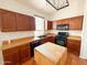 Kitchen boasts warm wood cabinets, tile flooring, and modern appliances at 18068 W Browning Dr, Surprise, AZ 85374