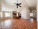 Spacious living room boasts tile flooring, ceiling fan and natural light from many windows at 18068 W Browning Dr, Surprise, AZ 85374