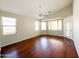 A bright and airy living room with hardwood floors, ceiling fan, and plenty of natural light at 18068 W Browning Dr, Surprise, AZ 85374