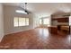 Spacious living room featuring tile flooring, large windows, and ceiling fan at 18068 W Browning Dr, Surprise, AZ 85374