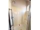 The shower features a glass door, shower head, and built in bench and window for natural light at 18068 W Browning Dr, Surprise, AZ 85374