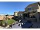 Backyard with patio, artificial grass, string lights, and desert landscaping at 2738 E Cherry Hill E Dr, Gilbert, AZ 85298