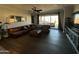 Spacious living room with dark floors, comfortable leather seating, and an entertainment center at 2738 E Cherry Hill E Dr, Gilbert, AZ 85298