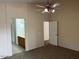Primary bedroom with carpet, ceiling fan and access to bathroom at 4051 W Buckskin Trl, Phoenix, AZ 85083