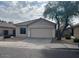 Tan two-car garage home with front yard landscaping at 4051 W Buckskin Trl, Phoenix, AZ 85083
