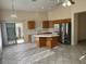 Kitchen with wood cabinets, island, and stainless steel appliances at 4051 W Buckskin Trl, Phoenix, AZ 85083