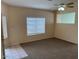 Spacious living room featuring carpeted floors and a large window at 4051 W Buckskin Trl, Phoenix, AZ 85083