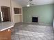 Living area with a fireplace, tile floors and access to kitchen at 4051 W Buckskin Trl, Phoenix, AZ 85083