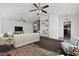 Spacious living room featuring hardwood floors, a stone fireplace, and kitchen view at 44824 N 10Th St, New River, AZ 85087