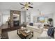 Open living room with a stone fireplace and ample natural light at 44824 N 10Th St, New River, AZ 85087