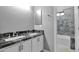 Bathroom features dual sinks with a marble countertop and tiled shower at 957 E Cedar Dr, Chandler, AZ 85249