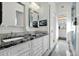 Bathroom features double sinks, elegant mirrors, and luxurious finishes plus a tv at 957 E Cedar Dr, Chandler, AZ 85249