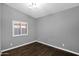 Empty bedroom is painted light gray and features a single window with natural light at 957 E Cedar Dr, Chandler, AZ 85249
