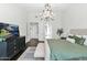 Bedroom features a TV, chandelier, and an ensuite bathroom with closet access at 957 E Cedar Dr, Chandler, AZ 85249