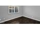 Empty bedroom features a single window with shutter and base trim throughout at 957 E Cedar Dr, Chandler, AZ 85249