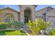Detailed front entrance showcasing an ornate door, archway, and verdant landscaping at 957 E Cedar Dr, Chandler, AZ 85249