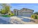Charming single-story home with a well-manicured lawn, three-car garage, and desert landscaping at 957 E Cedar Dr, Chandler, AZ 85249
