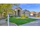 Inviting single-story home with lush green lawn, desert landscaping, and welcoming entrance at 957 E Cedar Dr, Chandler, AZ 85249
