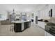 Open concept kitchen features a large island with seating, custom cabinetry, and modern appliances at 957 E Cedar Dr, Chandler, AZ 85249