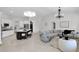 Bright open-concept living room with modern lighting, spacious island, and comfortable seating area at 957 E Cedar Dr, Chandler, AZ 85249