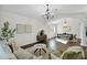 Bright living room with hardwood floors, stylish furniture, and decorative chandelier at 957 E Cedar Dr, Chandler, AZ 85249