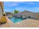 Backyard view showcasing the beautiful pool, outdoor kitchen, and lush landscaping at 957 E Cedar Dr, Chandler, AZ 85249