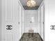 A luxurious walk-in closet is brightly lit with seating and custom shelving for optimal organization at 957 E Cedar Dr, Chandler, AZ 85249