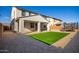 Artificial turf, covered patio, and trampoline in backyard at 14271 W Alameda Rd, Surprise, AZ 85387