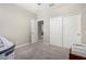 Well-lit bedroom with double doors and closet at 14271 W Alameda Rd, Surprise, AZ 85387