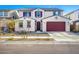 Two-story house with red garage door and landscaping at 14271 W Alameda Rd, Surprise, AZ 85387