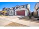 Two-story house with red garage door, desert landscaping, and a driveway at 14271 W Alameda Rd, Surprise, AZ 85387